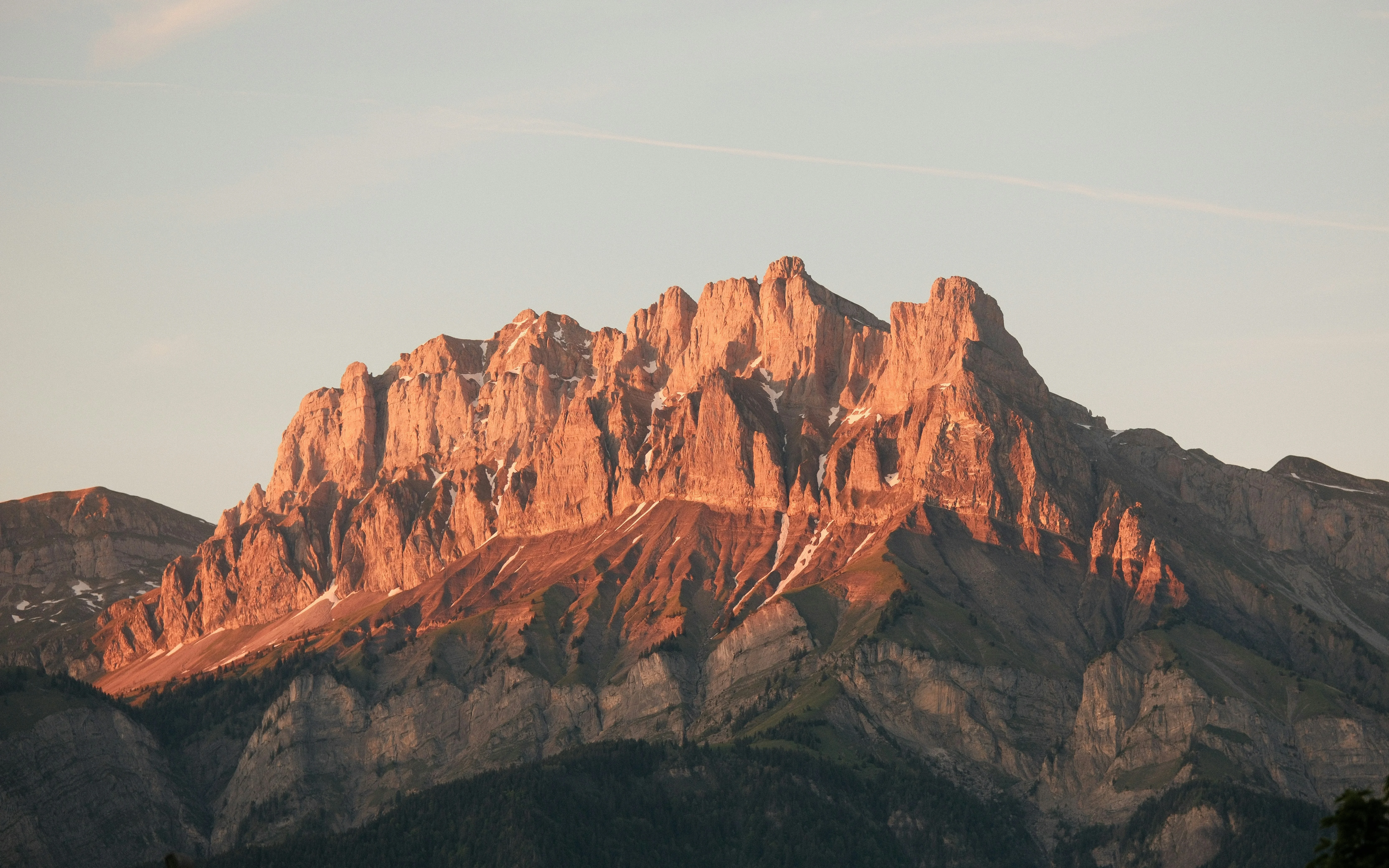 Jagged mountain peak illuminated by golden hour sunlight. — reaching peak performance