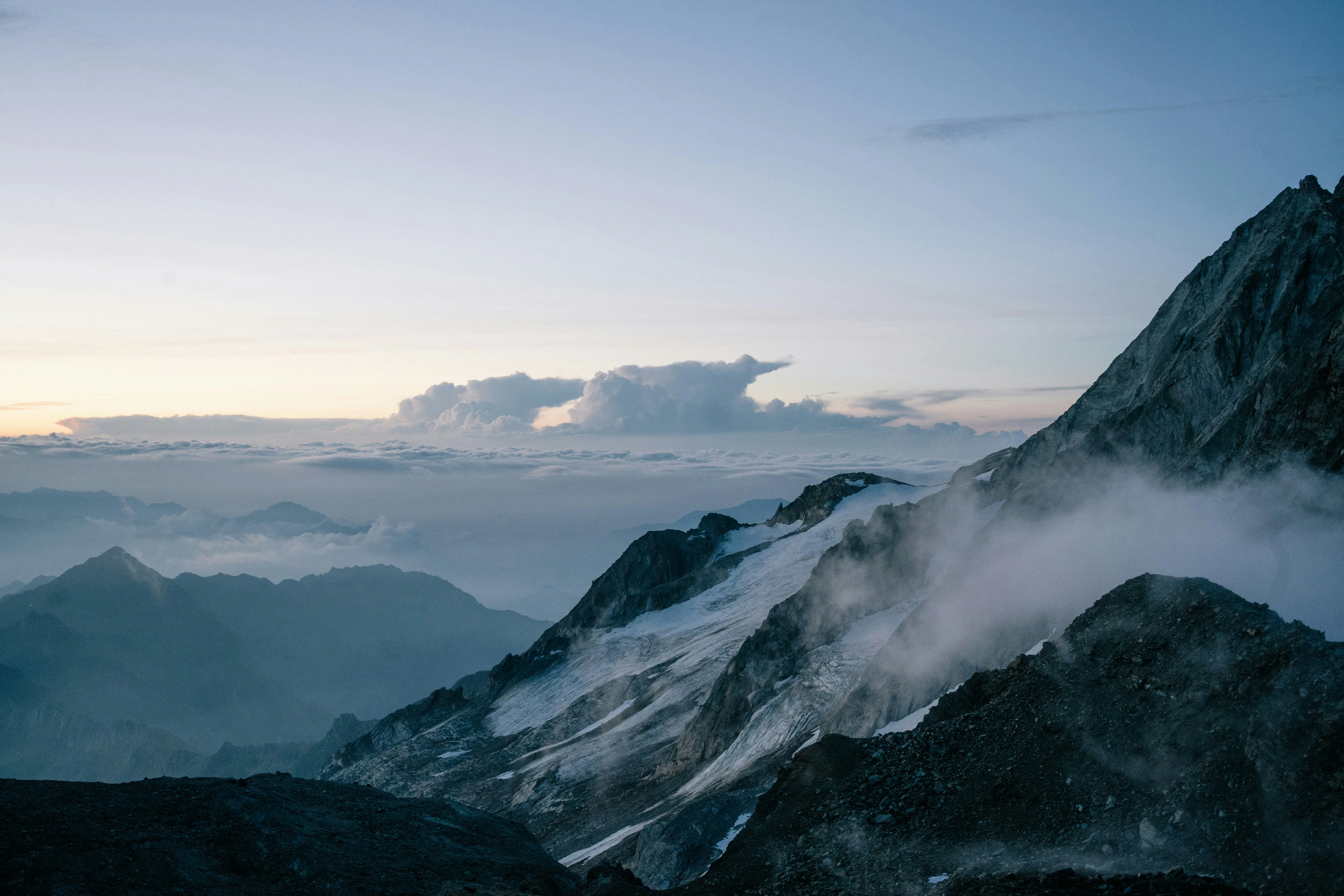 Misty mountain peaks at dawn with soft clouds. — reaching peak performance