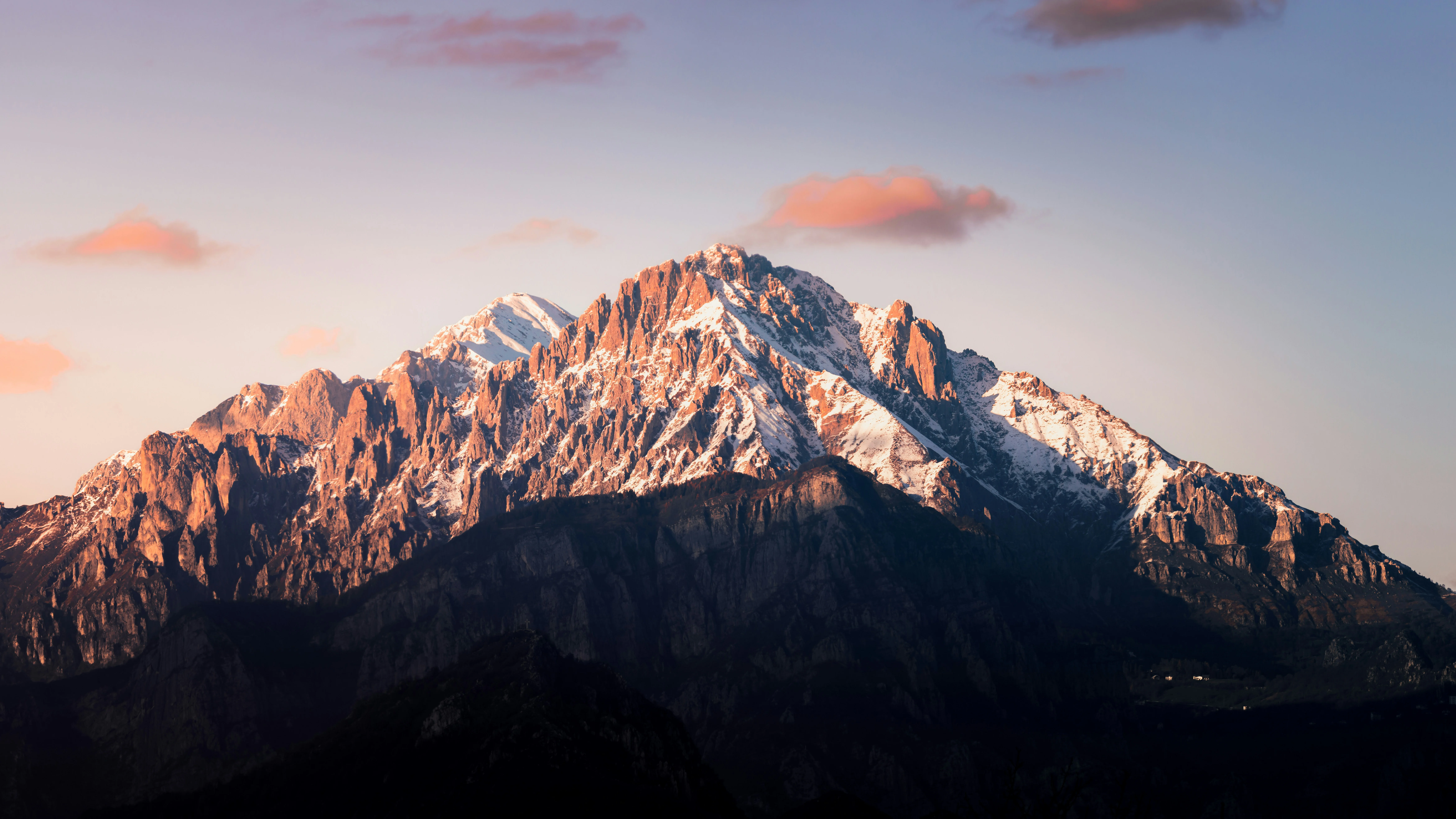 a snow covered mountain with a pink sky in the background — reaching peak performance
