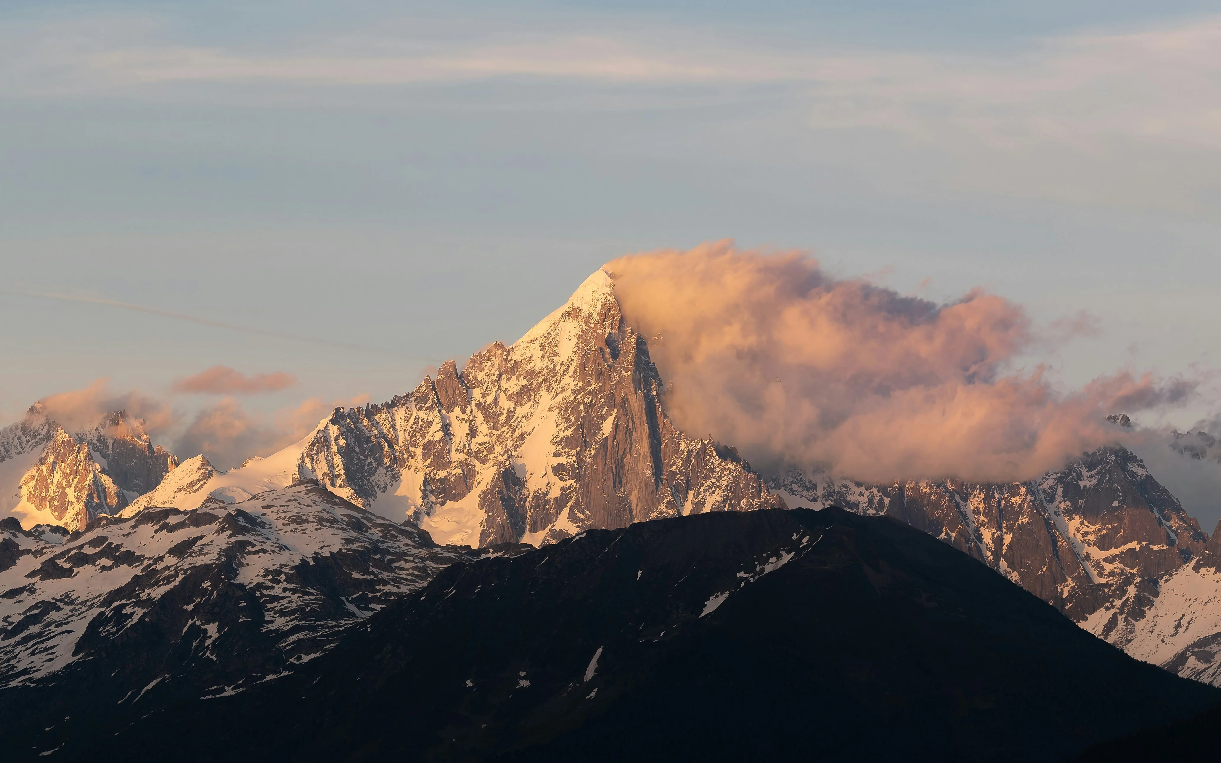 Snow-capped mountain peak illuminated by sunset light. — reaching peak performance