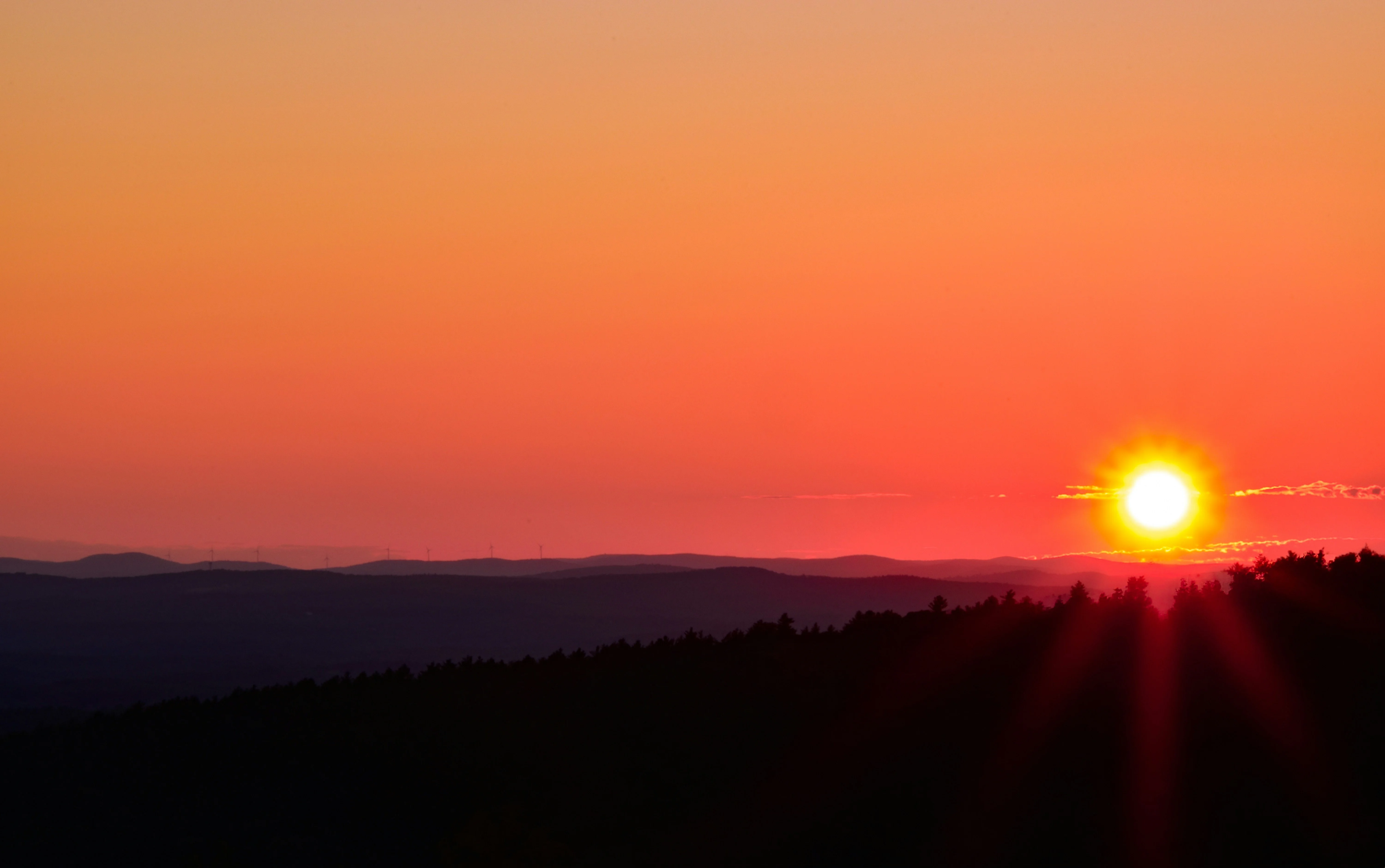 The sun is setting over a mountain range — reaching peak performance