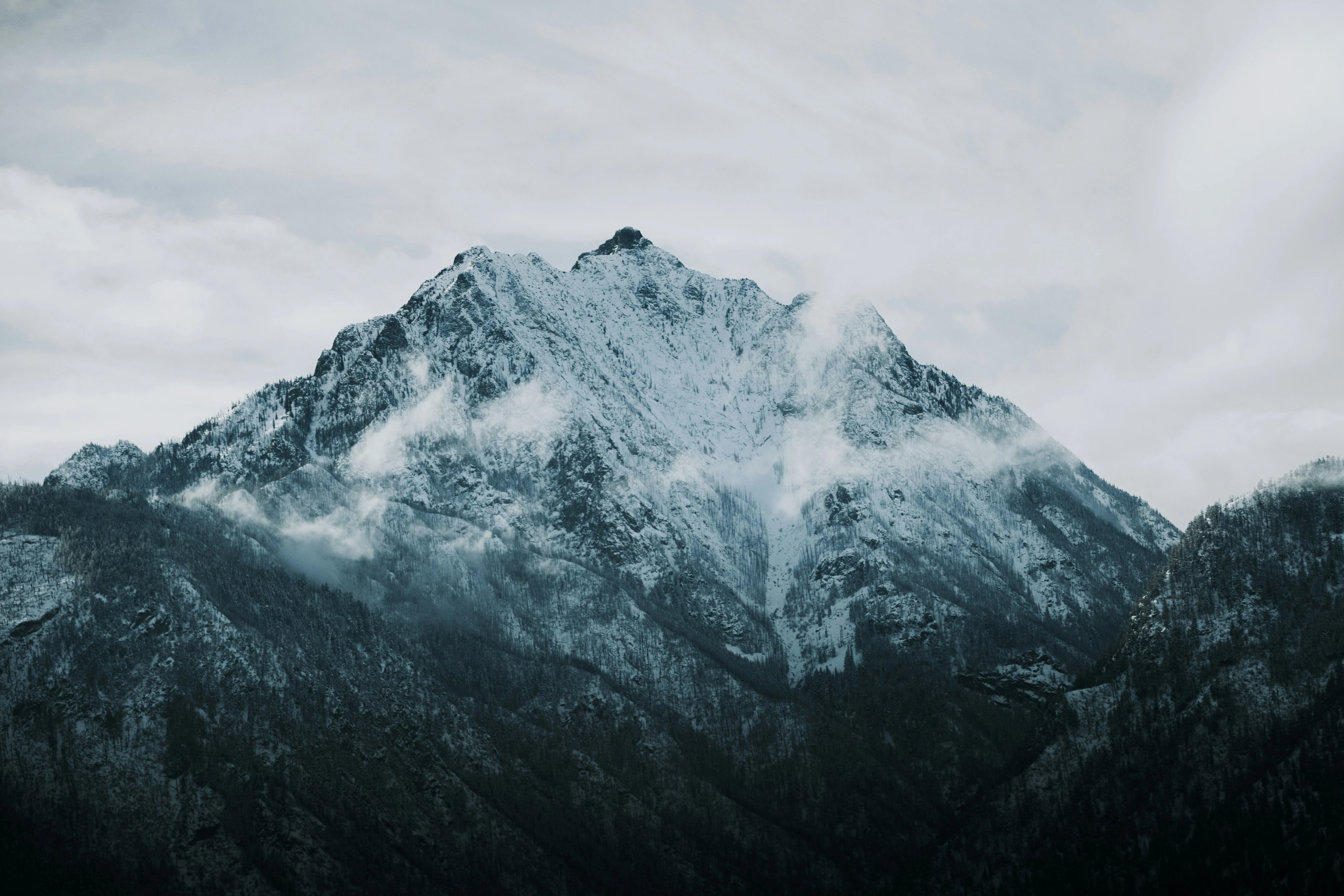 A mountain covered in snow under a cloudy sky — reaching peak performance