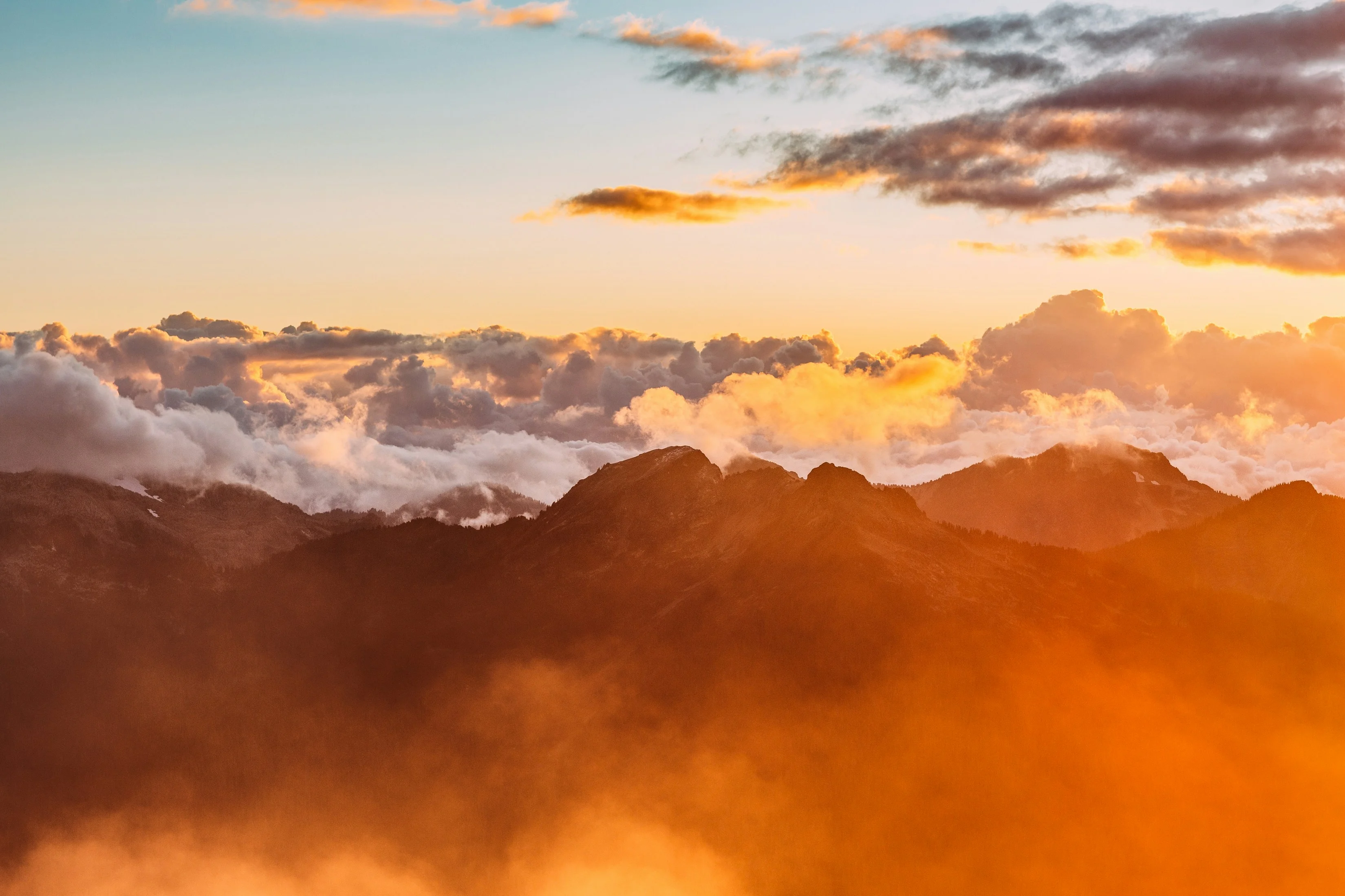 landscape photography of mountains with cloudy skies during golden hour — reaching peak performance