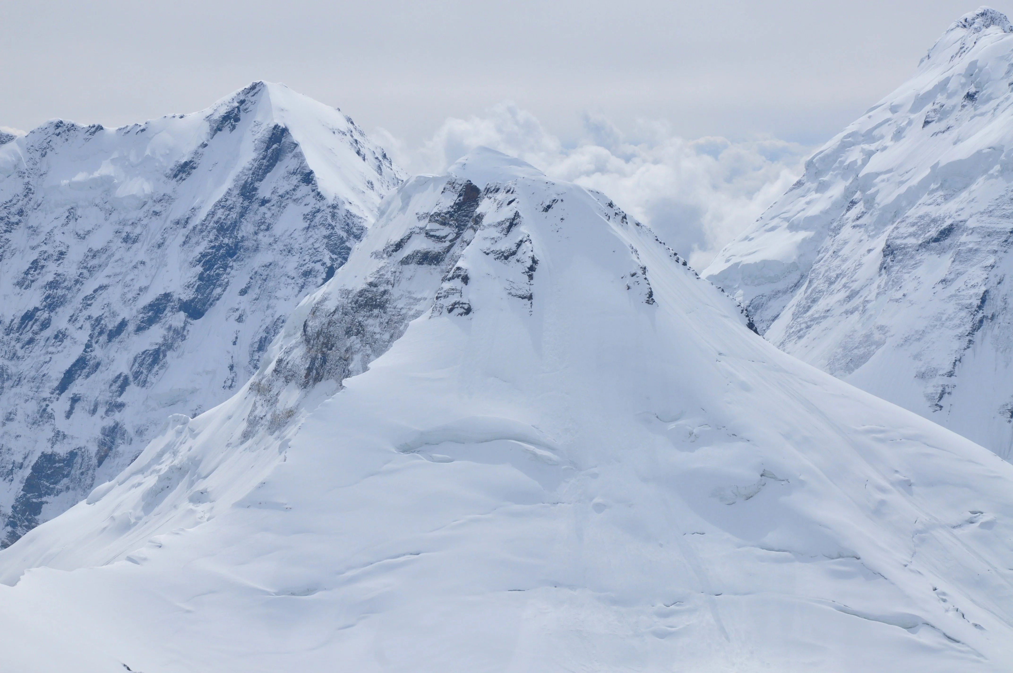a snowy mountain with a valley below — reaching peak performance